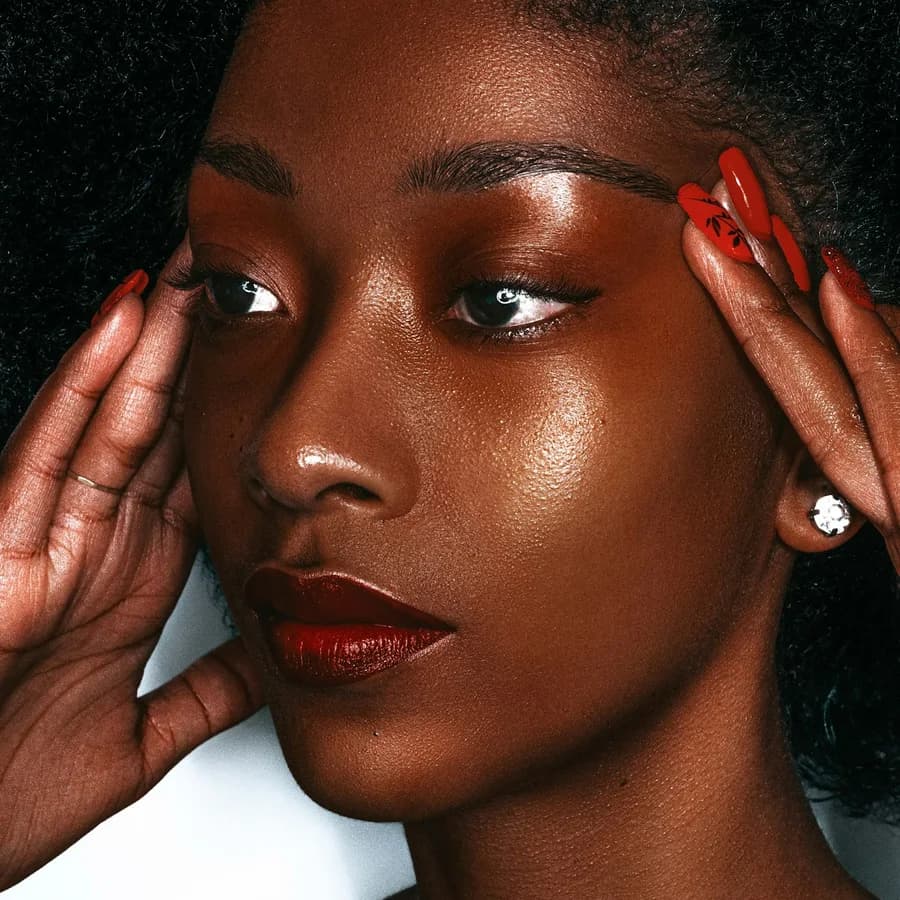 Beauty portrait with a bold red lip and matching manicure